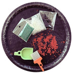 LUCKY TO HAVE® Lucky Mix mini sweeper organizing and collecting small jewelry beads on a tray, enabling precise handling of fine craft materials. Fine things matter.