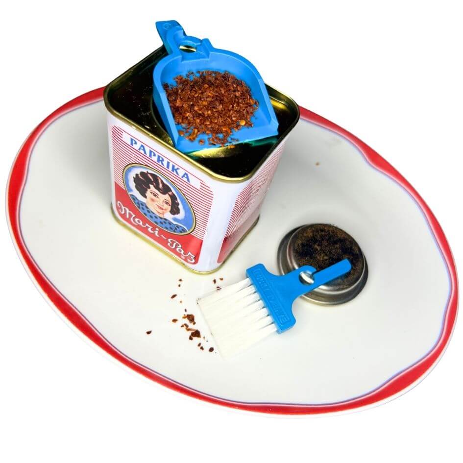 LUCKY TO HAVE® Bora Bora mini pan and broom holding crushed paprika flakes on a spice tin, enabling precise handling and clean transfer of fine kitchen spices - fine things matter.