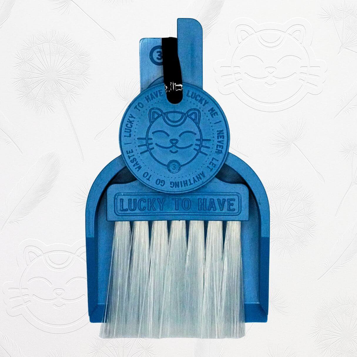 LUCKY TO HAVE® ocean blue mini dustpan set presented in front of the signature brand-style wallpaper.
