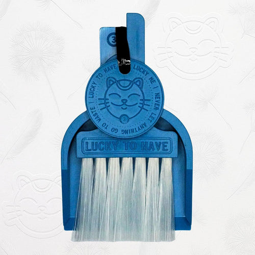 LUCKY TO HAVE® ocean blue mini dustpan set presented in front of the signature brand-style wallpaper.