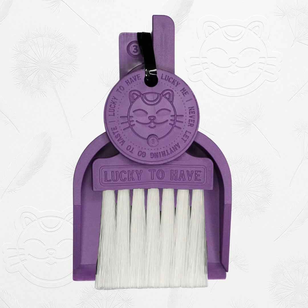 LUCKY TO HAVE® purple mini dustpan set presented in front of the signature brand-style wallpaper.