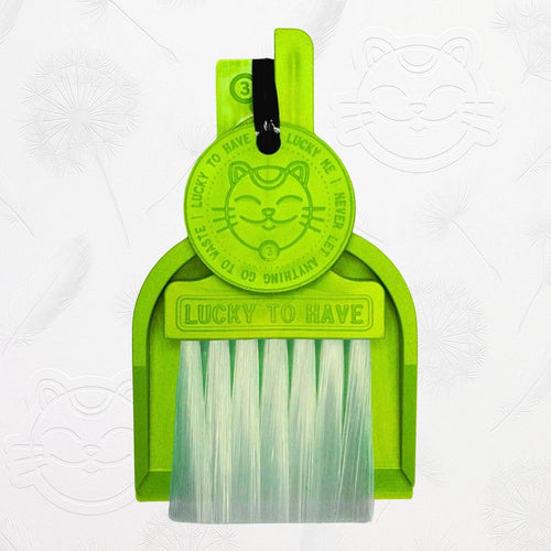 LUCKY TO HAVE® neon green mini dustpan set presented in front of the signature brand-style wallpaper.