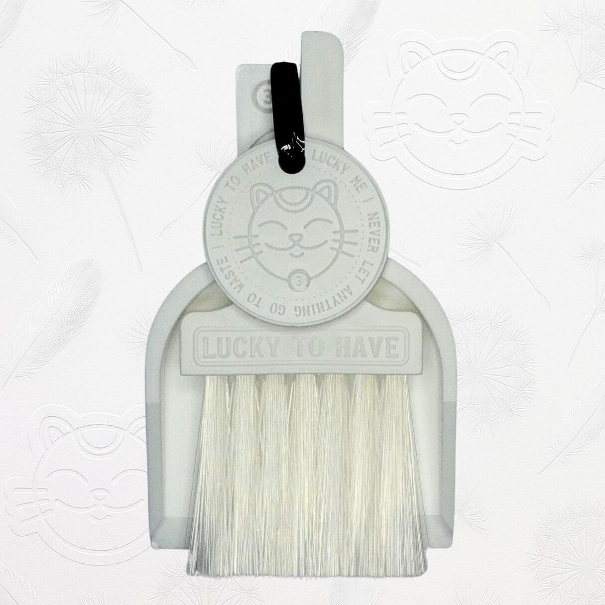 LUCKY TO HAVE® white mini dustpan set presented in front of the signature brand-style wallpaper.