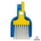 LUCKY TO HAVE® Mix: Mini sweeper brush and tray in a classic blue and yellow color scheme, perfectly nested on a white background. This detail shot without the coin showcases the slim design and elegant variety of the world's smallest broom set. Fine things.
