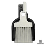 LUCKY TO HAVE® Mix: Mini sweeper brush and tray in black and white, perfectly nested on a white background. This detail shot showcases the slim design of the world's smallest sweeper set for the fine things.
