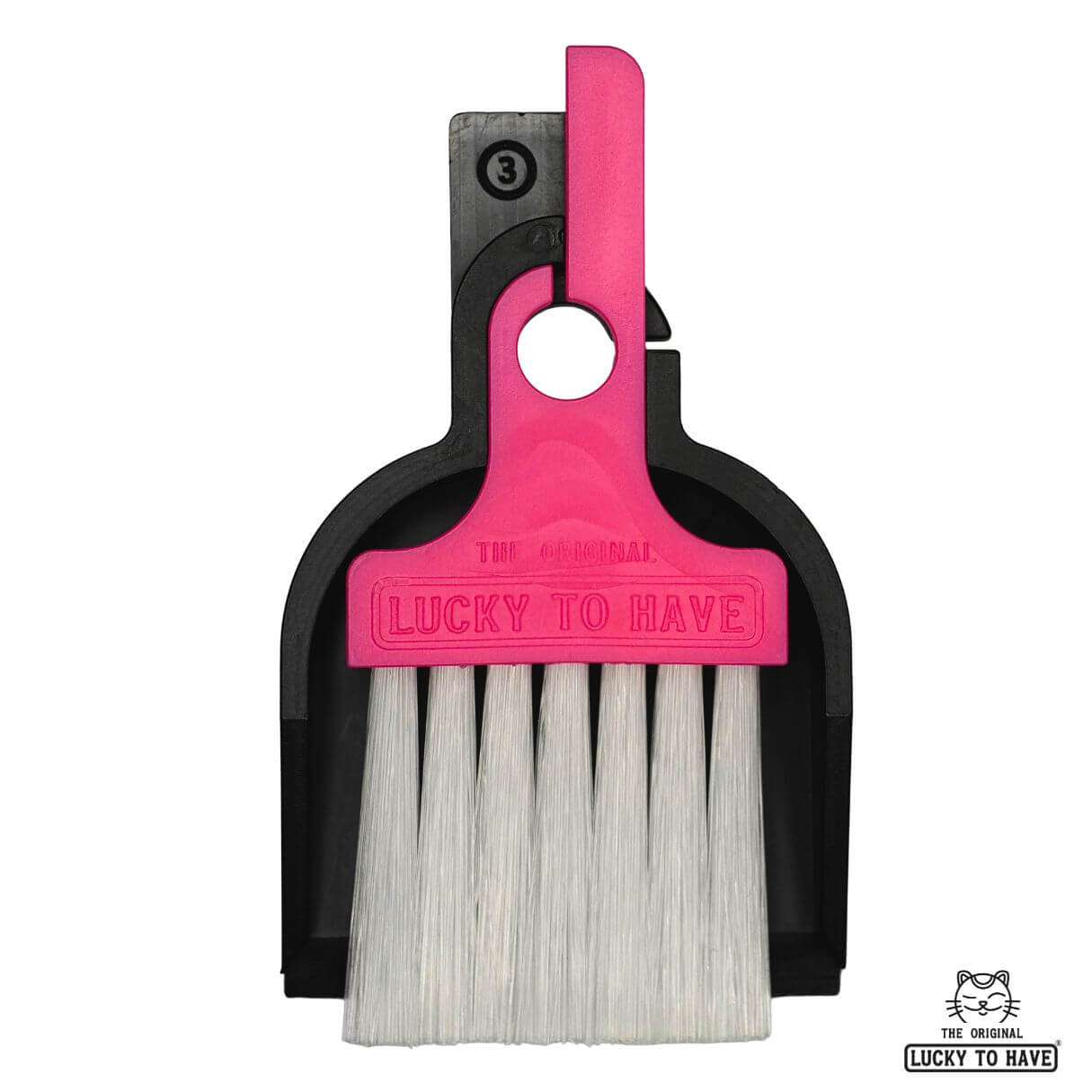 LUCKY TO HAVE® Mix: Mini sweeper brush and tray in a classic black and pink color scheme, perfectly nested on a white background. This detail shot without the coin showcases the slim design and cute variety of the world's smallest broom set. Fine things.