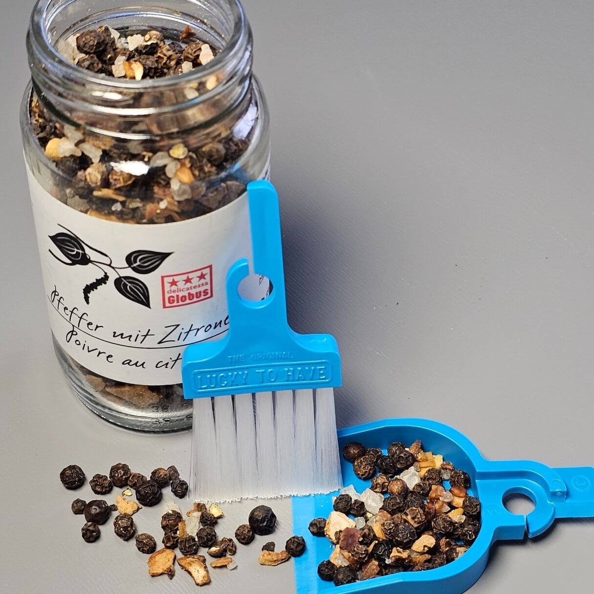 LUCKY TO HAVE dustpan saving spices by pouring them back into the container to avoid waste.