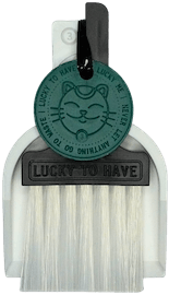 LUCKY TO HAVE® – the smallest broom and dustpan set – shown as a clean symbolic icon, representing smart sweeping for weed, herbs, powders and fine crumbs, and playful enough to double as a compact fidget toy.