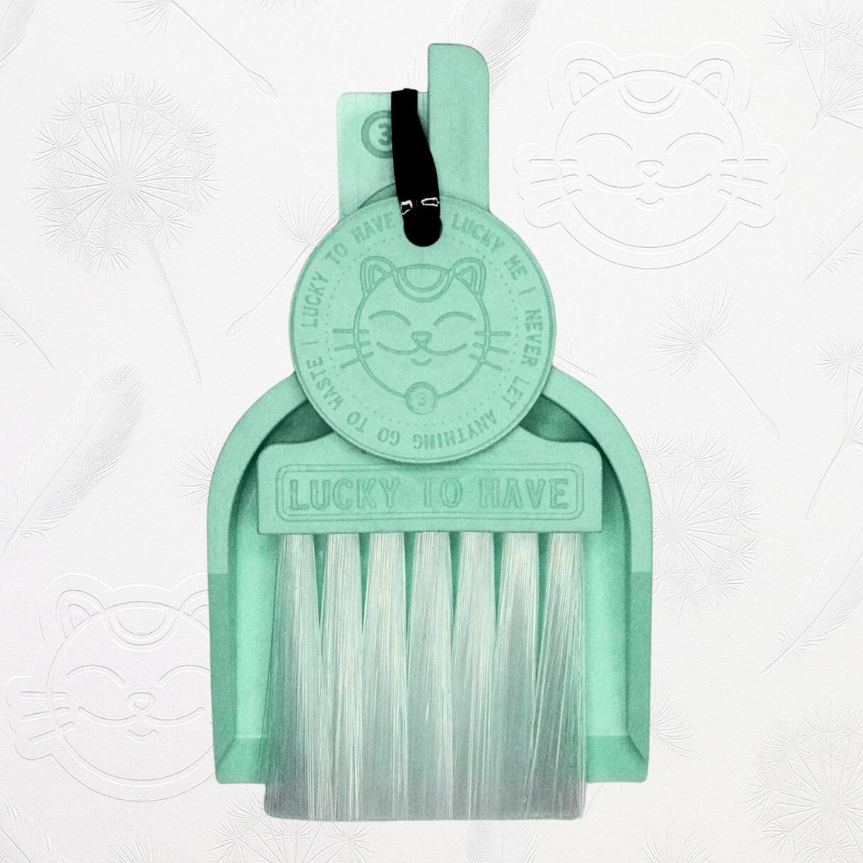 LUCKY TO HAVE® mint mini dustpan set presented in front of the signature brand-style wallpaper.
